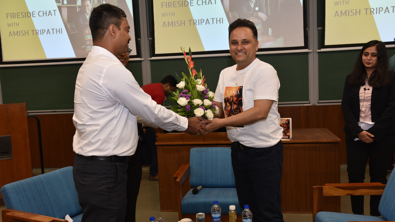 Librarian Handing over the Gift to Mr. Amish Tripathi